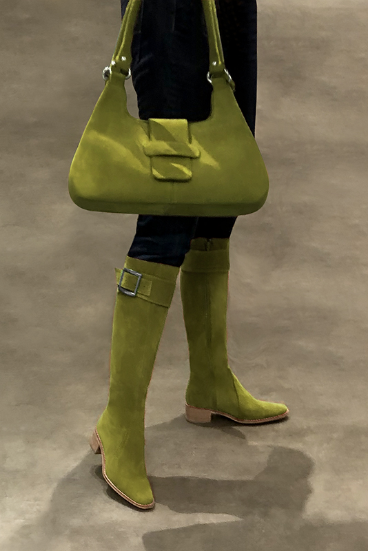 Pistachio green matching hnee-high boots, bag and calf bracelets. Worn view - Florence KOOIJMAN